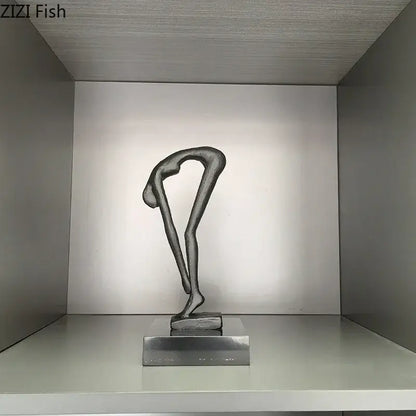 A sleek minimalist black metal gymnast statue desk ornament in an elegant bending pose for decorbites gymnast statue decor