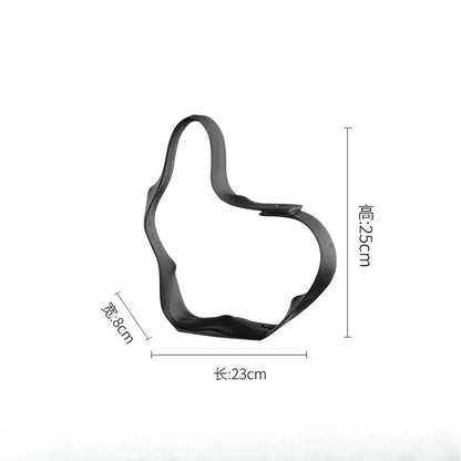 Black leather-like thumbs-up cookie cutter 23cm by 8cm paired with abstract black resin ring sculpture home decor decorbites geometric