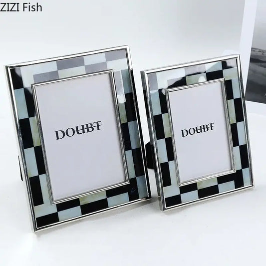 Two elegant black and silver checkered photo frames with a sleek metallic finish for bedroom desktop decorbites black white decor