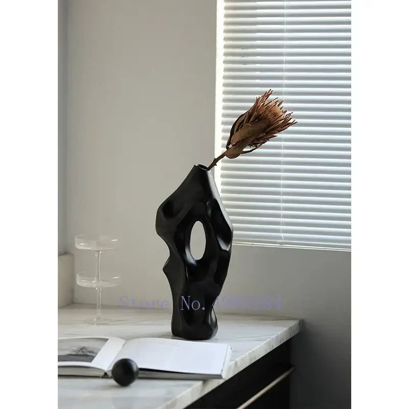 Black ceramic abstract ceramic vase with sculptural form and central oval opening for living room decorbites black decor