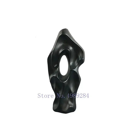 Abstract black resin sculpture with smooth flowing contours and central oval opening for decorbites black ceramic vase decor