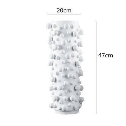 A tall white ceramic vase with irregular bumps features a black white abstract design for decorbites living room decor