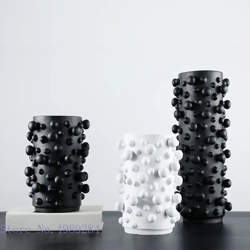 Three cylindrical resin vases in black white with irregular bumps for decorbites black white abstract living room decor