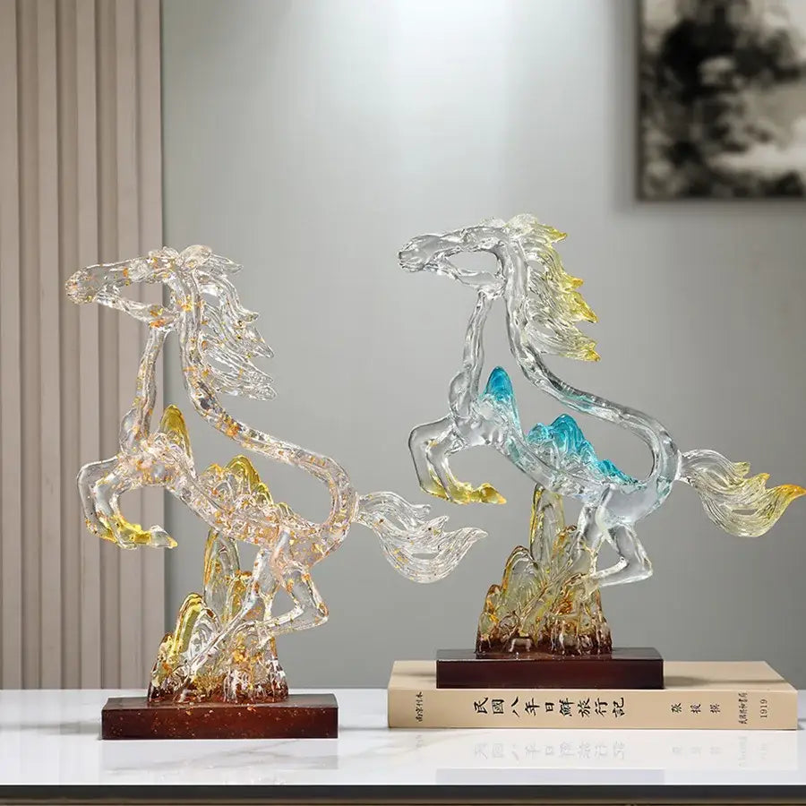 Two translucent crystal horse statues with blue and gold accents on dark wooden bases for living room decorbites decor