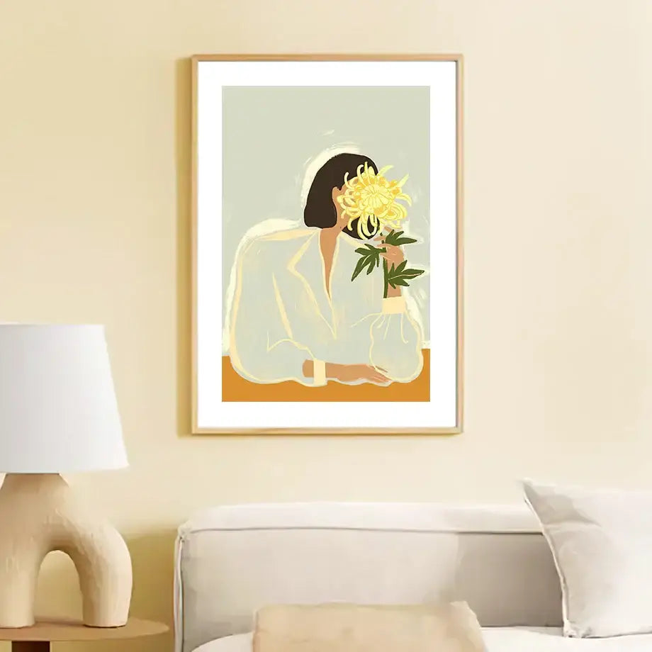 Minimalist wall art canvas painting of an abstract girl hand holding a yellow chrysanthemum in soft pastel tones