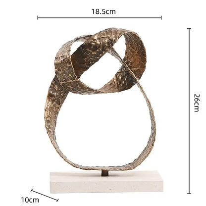 Bronze textured metal abstract geometric sphere pendant sculpture with intertwined loops on white stone base for decor