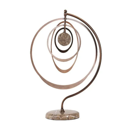 Abstract bronze geometric sphere pendant sculpture with concentric rings and textured disc on marble base for living room decor