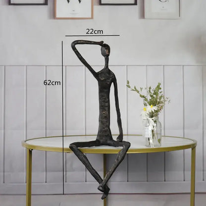 Abstract bronze metal human sculpture with elongated limbs in contemplative pose for living room decorbites abstract metal decor