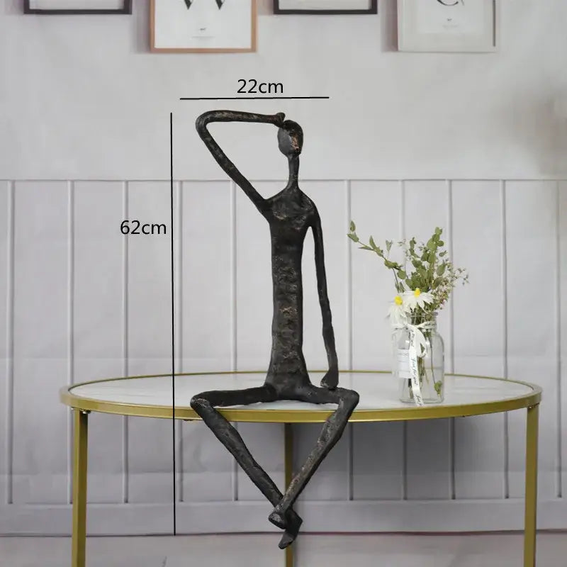 Black abstract metal human sculpture with elongated limbs and textured finish for living room decorbites abstract metal decor