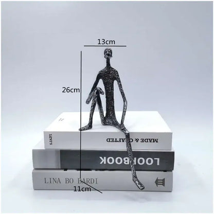 A sleek black textured abstract metal human sculpture figurine for living room decor by decorbites