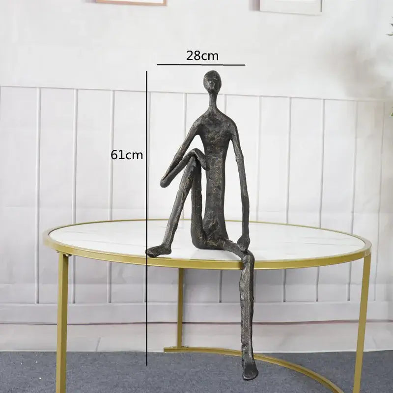 A sleek dark bronze abstract metal human sculpture with elongated limbs ideal for living room decorbites decor