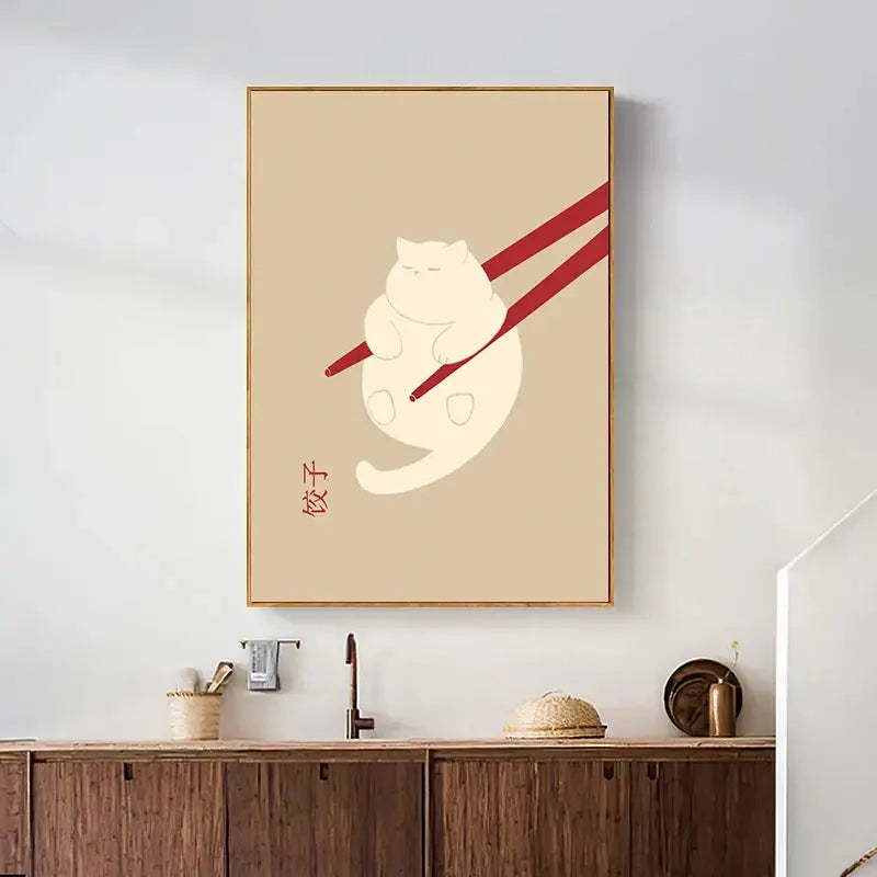 Beige-framed canvas wall art featuring a minimalist white lazy cat illustration held by red chopsticks with dumplings text