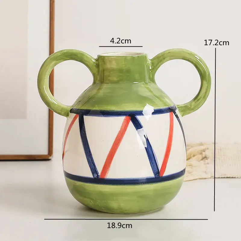 Abstract ceramic hydroponic vase with double ear green handles, white body, red and blue stripes, and solid green base