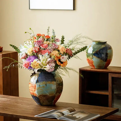 A decorbites ceramic vase featuring a glossy finish and abstract floral design with color stitching in blue orange and green