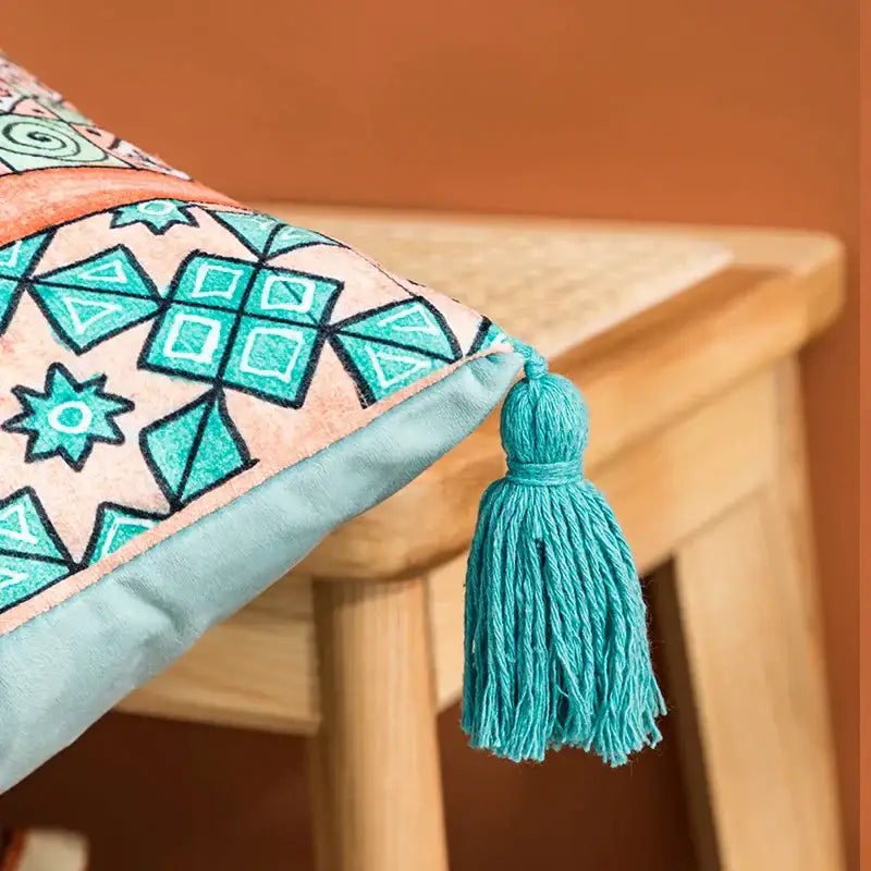 A coral and teal abstract geometric cushion cover with turquoise tassel and light blue piping for decorbites decorbites abstract geometric pillow