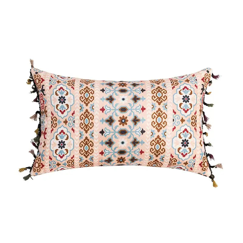 Rectangular cushion cover with soft pink base and abstract geometric patterns in coral teal with tassel decorbites accents