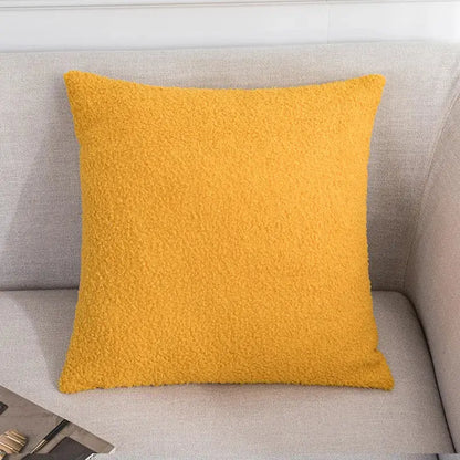 A cozy mustard-yellow fleece pillow on a gray couch complements decorbites abstract geometric pillow cover decor