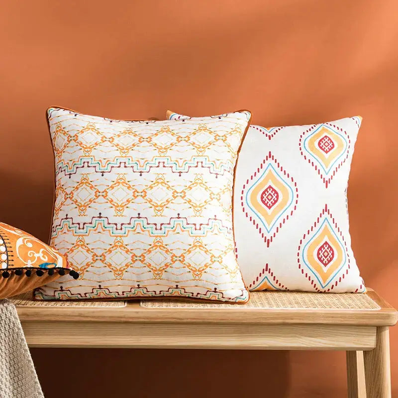 Two square cushion covers with decorbites abstract geometric printed patterns in orange and blue for living room decor