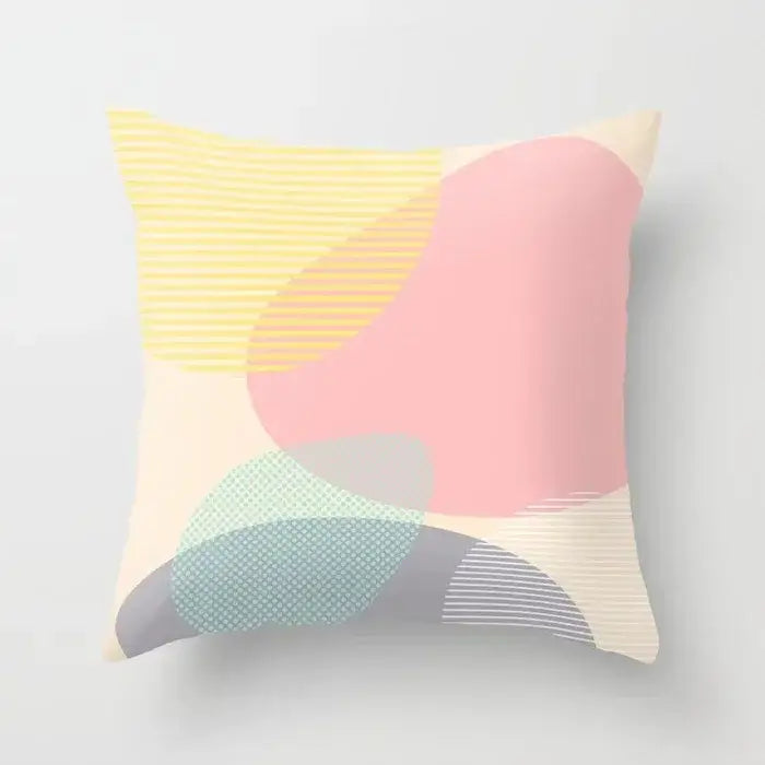 Pastel-colored abstract geometric stitch print pillow cover with soft pink yellow and mint green shapes on cream decorbites geometric stitch decor