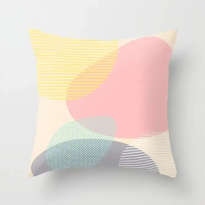 Pastel-colored abstract geometric stitch print pillow cover with soft pink yellow and mint green shapes on cream decorbites geometric stitch decor