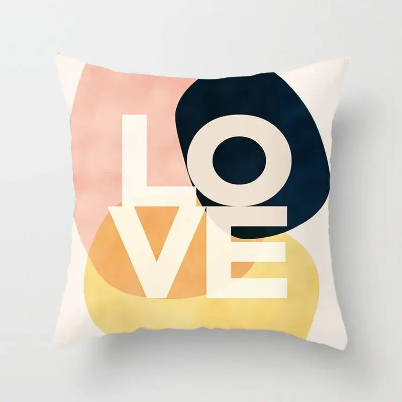 A square pillow cover with bold love text and peach yellow navy watercolor washes decorbites geometric stitch print