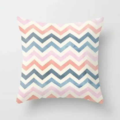 A square pillow cover with a decorbites geometric stitch print in soft pink coral and muted blue on creamy white background
