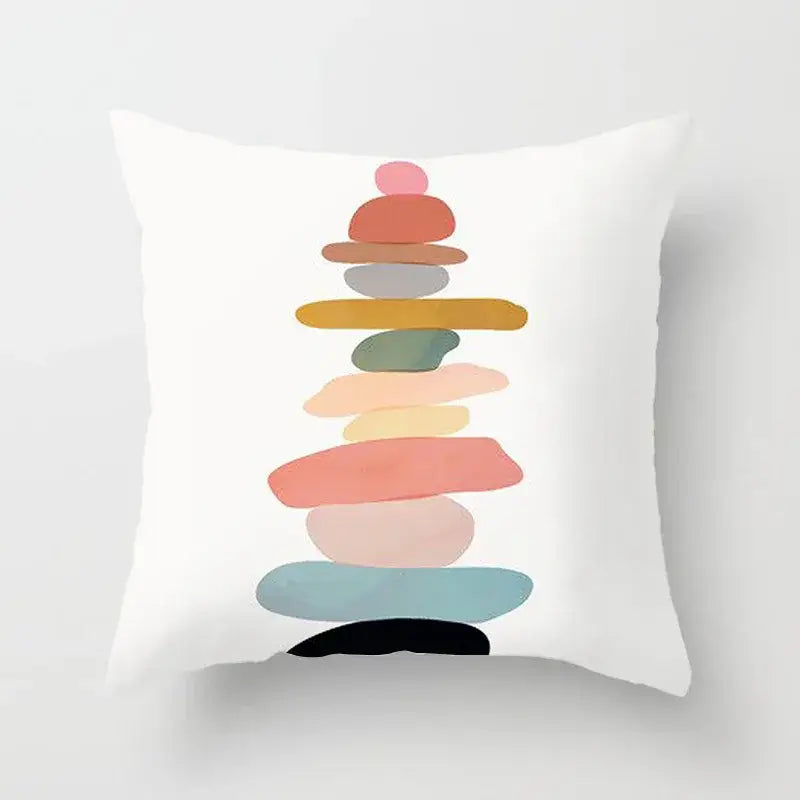 White throw pillow cover with abstract geometric stitch print featuring a stack of pastel and earthy stones decorbites decor