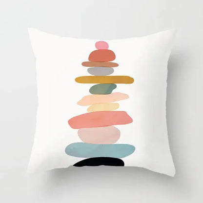 White throw pillow cover with abstract geometric stitch print featuring a stack of pastel and earthy stones decorbites decor