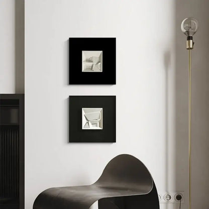 Two black-framed decorbites abstract geometric wall decorations with silver designs for orange and white living room decor