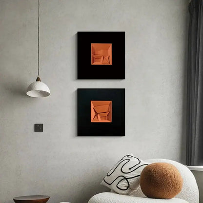 Two square-framed decorbites abstract geometric wall decoration featuring vibrant orange 3d forms on black background