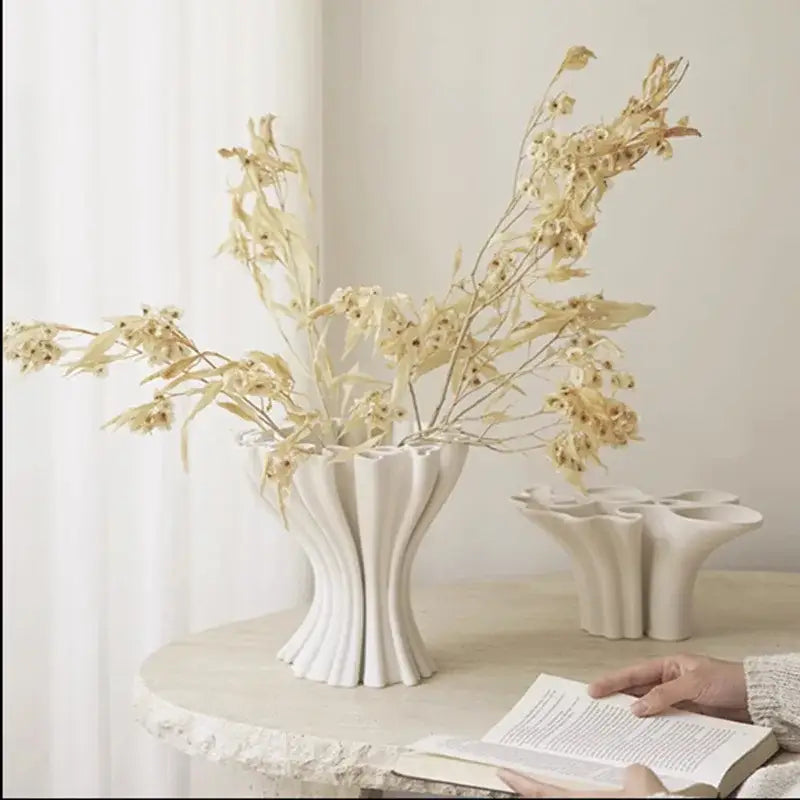 White abstract geometry ceramic fluted vase with triple opening holding dried beige flowers for living room decorbites abstract geometry