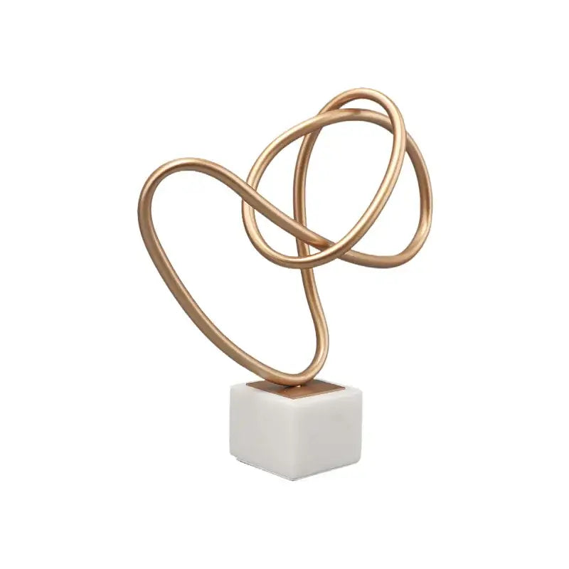 Gold-toned abstract wire sculpture on white marble base decorbites gold line geometric metal decor for living rooms