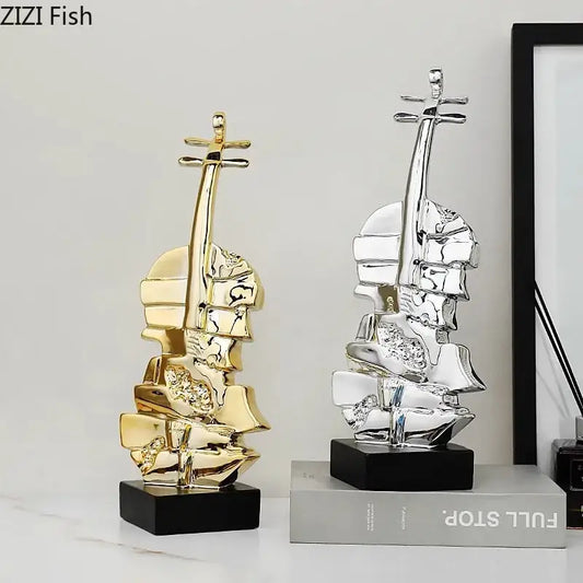 Abstract gold and silver violin sculpture with reflective segmented surfaces on black bases for living room decorbites decor