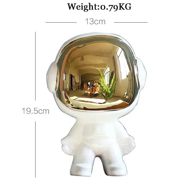 White ceramic astronaut figurine with reflective gold helmet alongside abstract gold resin statue for living room decor