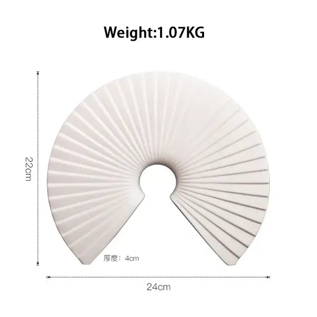 White ceramic fan-shaped decorative object with radial ridges and central hole for abstract gold resin statue decor