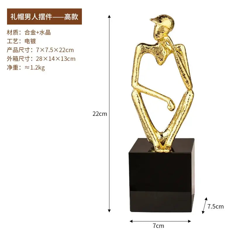 Golden metallic decorbites golden hat thinker figure seated with crossed leg and hand on knee for living room decor