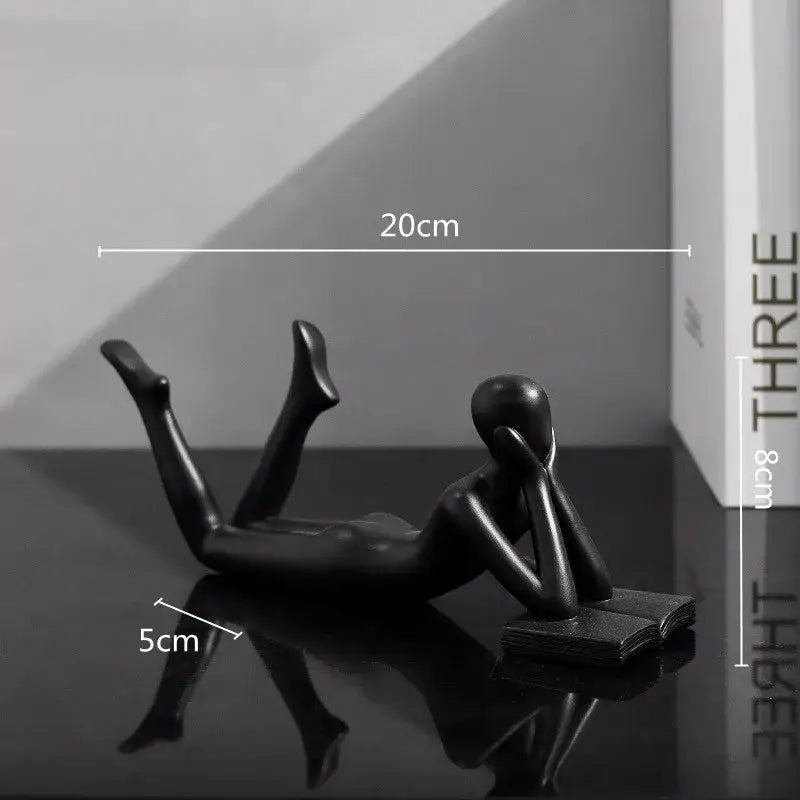 Black glossy resin figurine of a reclining thinker reader man for living room decor golden thinker reader sculpture