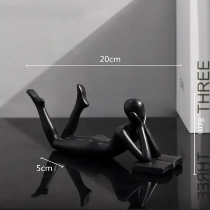 Black glossy resin figurine of a reclining thinker reader man for living room decor golden thinker reader sculpture