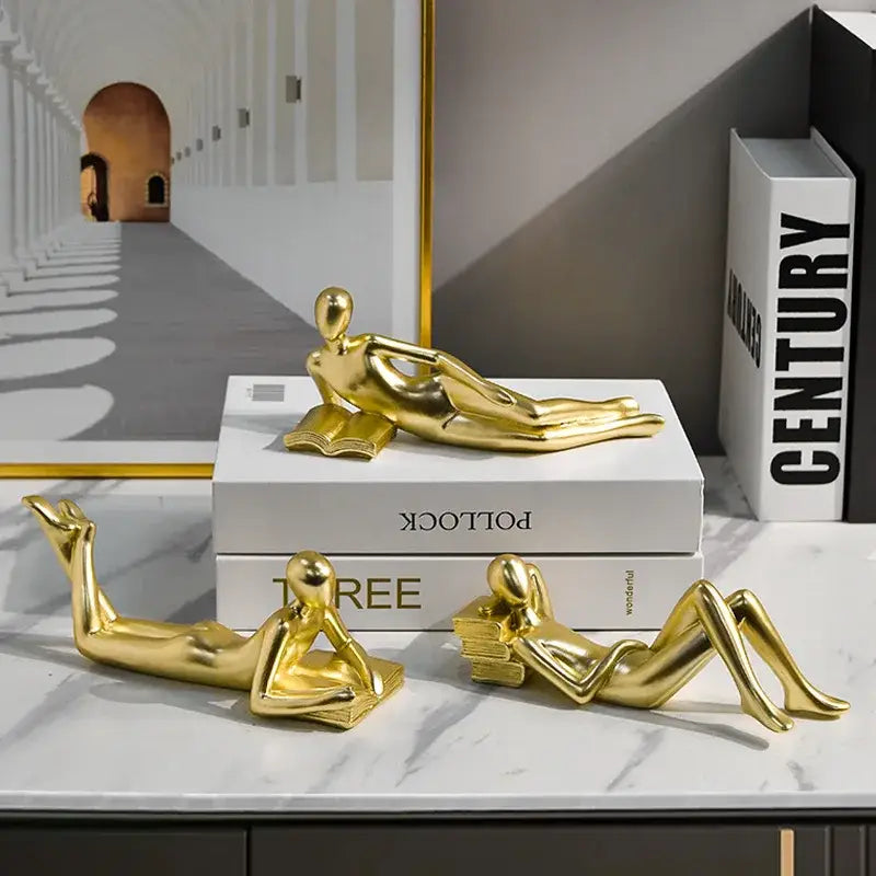Golden glossy abstract thinker reader man figurines lounging with books for living room decor