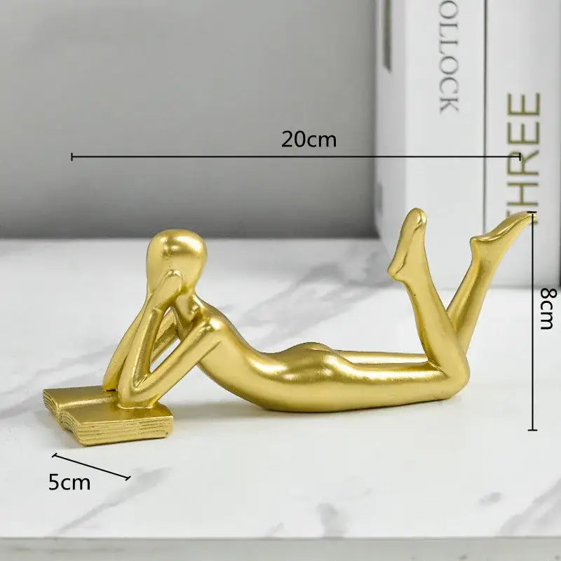 Abstract golden thinker reader man figurine with smooth metallic finish and stylized design for living room decor