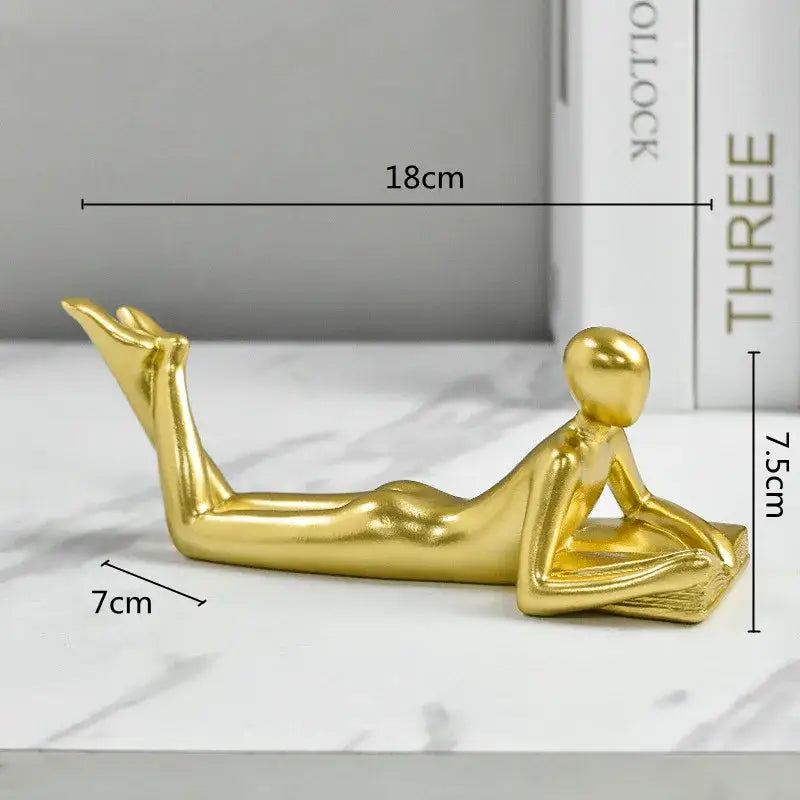 Golden thinker reader man figurine with sleek elongated limbs and smooth contours for living room decor