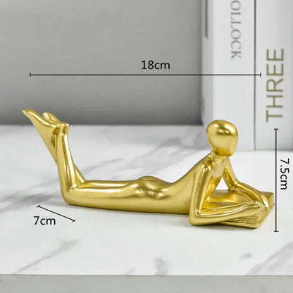 Golden thinker reader man figurine with sleek elongated limbs and smooth contours for living room decor