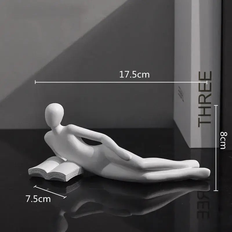 White ceramic abstract golden thinker reader man figurine reclining on open book for living room decor