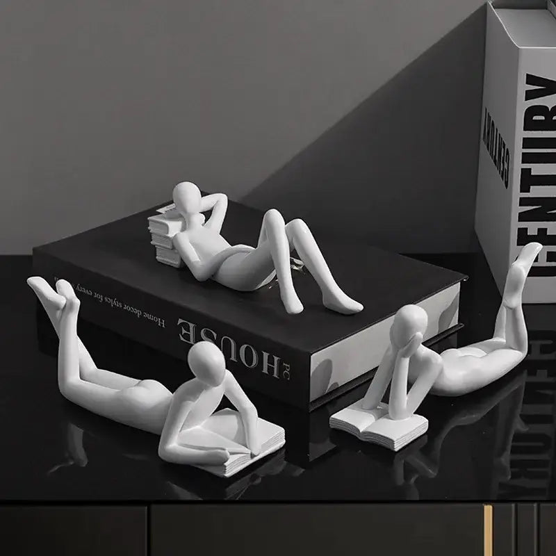 White ceramic minimalist human figurines in reading poses for abstract golden thinker reader man living room decor