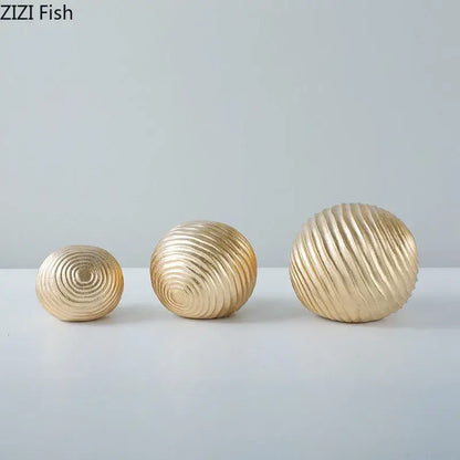 Set of three gold-toned decorative golden wave balls with concentric ridged patterns for living room decor