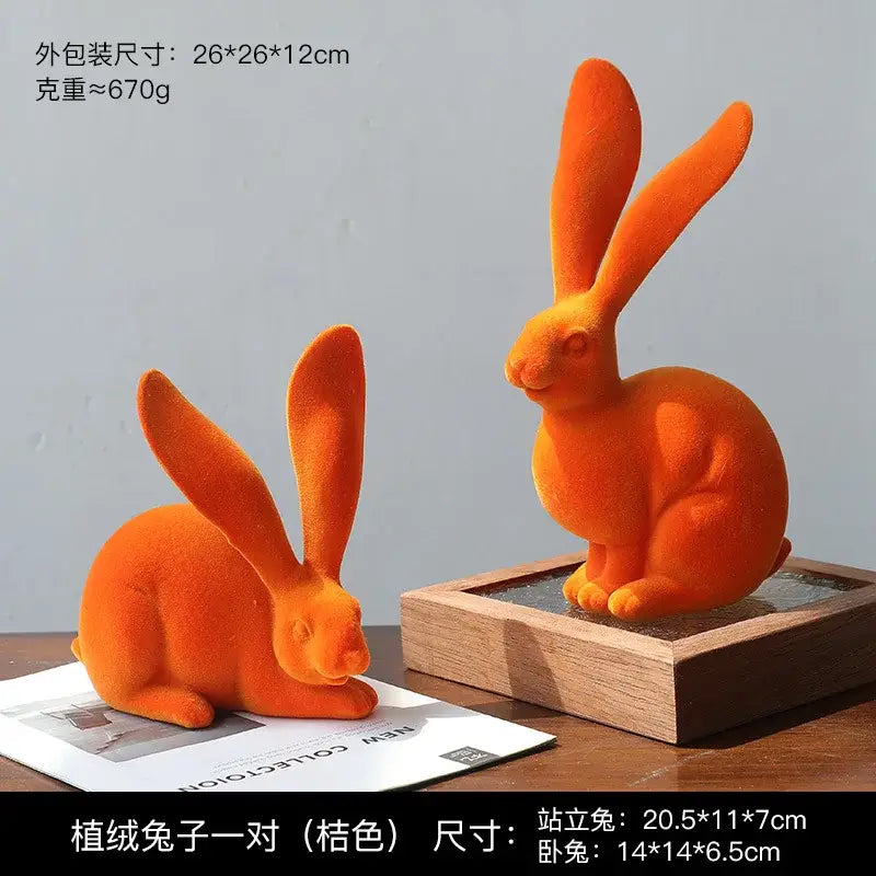 Orange plush abstract rabbit figurines made of soft velour material for living room decor art display