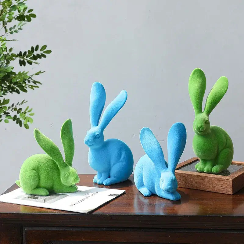 Set of three vibrant green and blue abstract rabbit figurines with soft matte resin finish for living room decor
