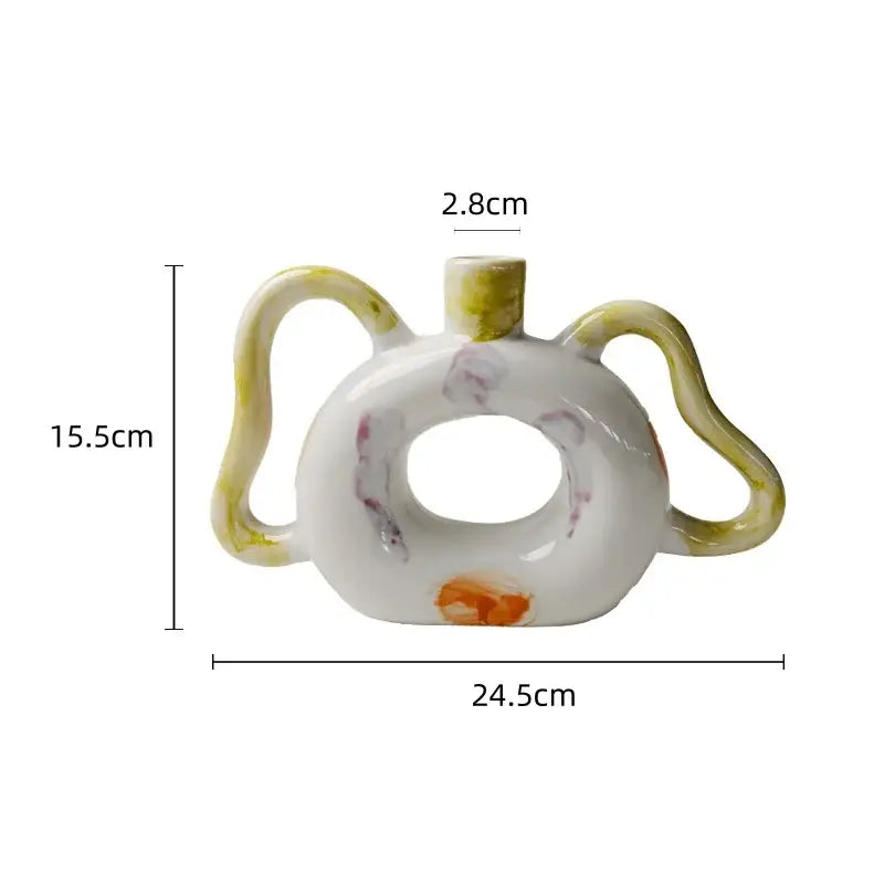 A white ceramic miniature teapot with donut-shaped body and yellow abstract handle decorbites abstract handle ceramic vase set