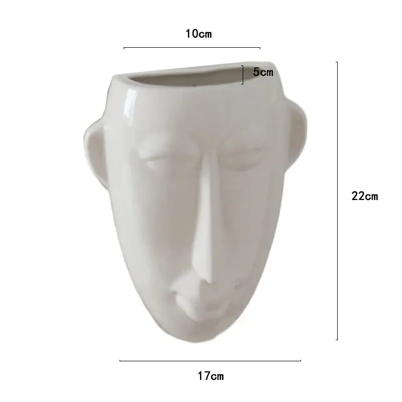 A sleek white ceramic vase featuring abstract human face design by decorbites for modern living room decor