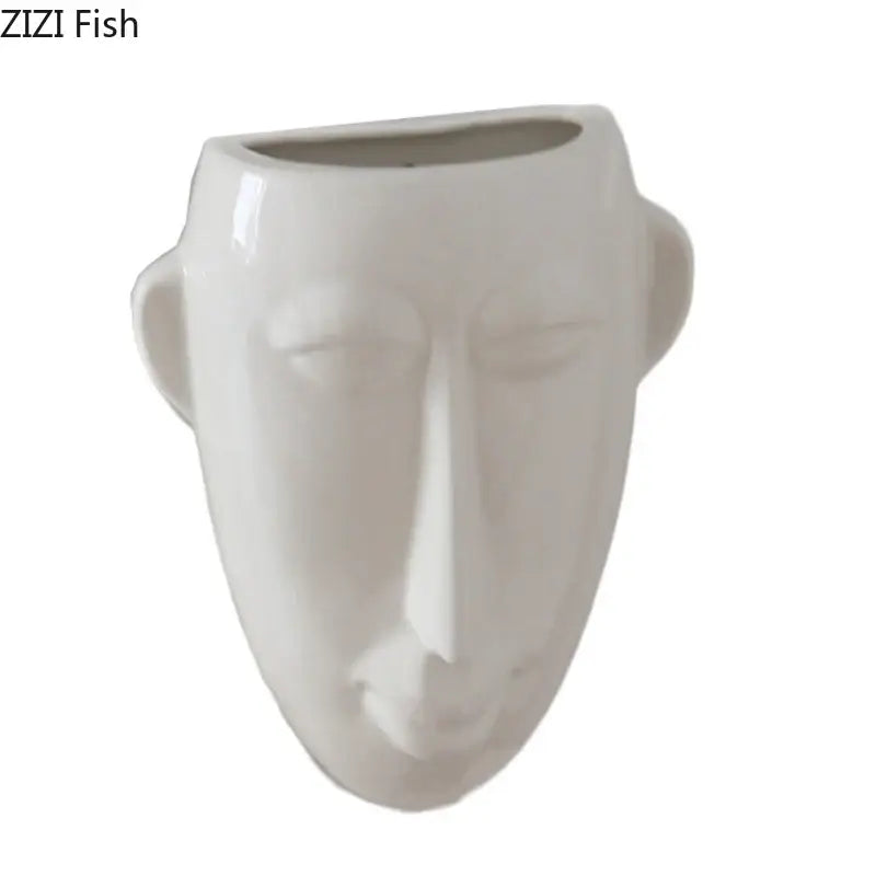 A sleek white ceramic vase shaped like an abstract human face with minimalist features for living room decorbites decor